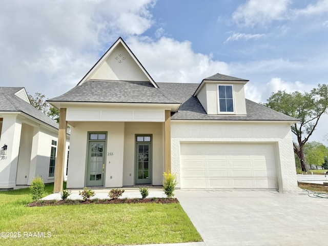 view of front of property featuring roof with shingles, a front lawn, driveway, covered porch, and a garage
