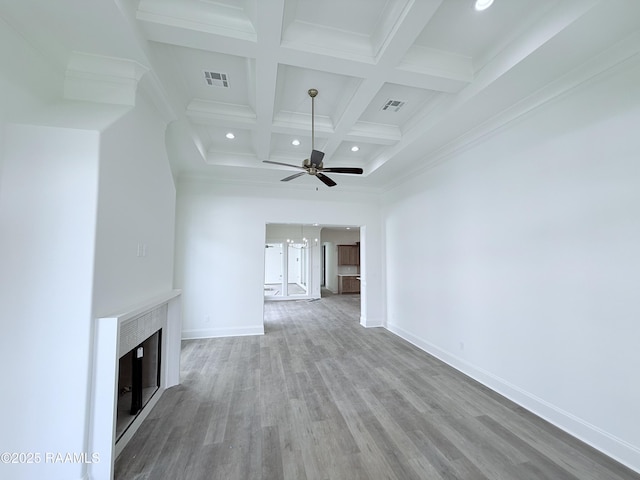 unfurnished living room with a ceiling fan, wood finished floors, beam ceiling, and visible vents
