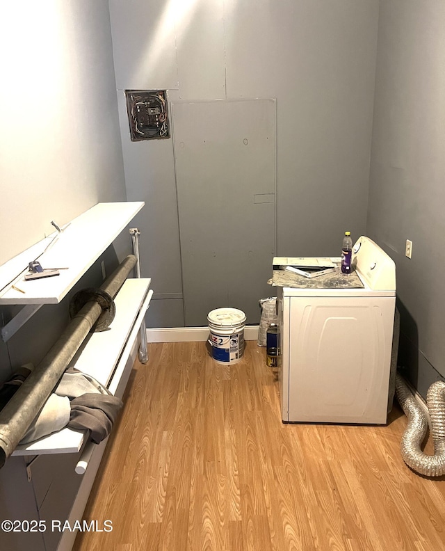 washroom featuring washer / clothes dryer and light hardwood / wood-style flooring