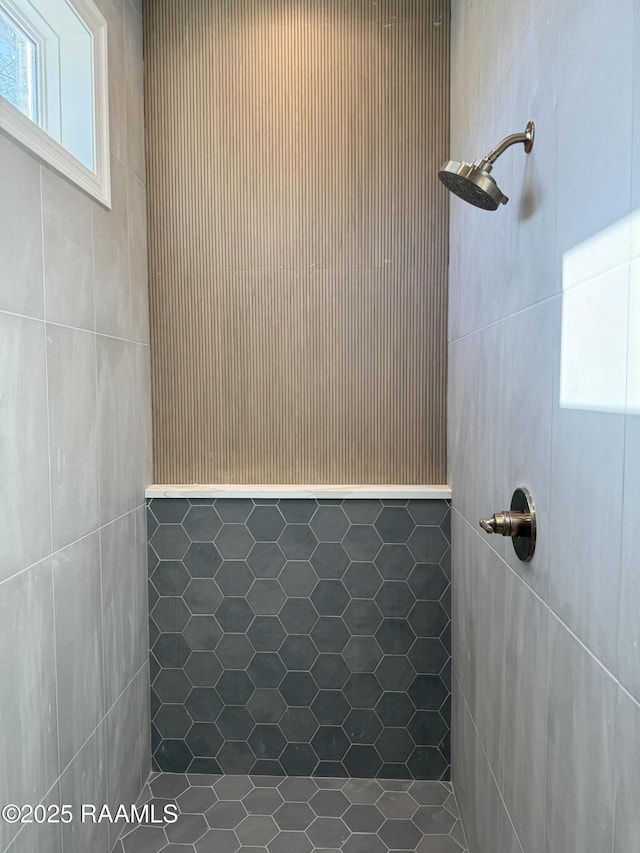 bathroom with tiled shower