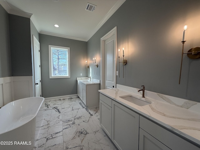 bathroom with vanity, a tub, and crown molding