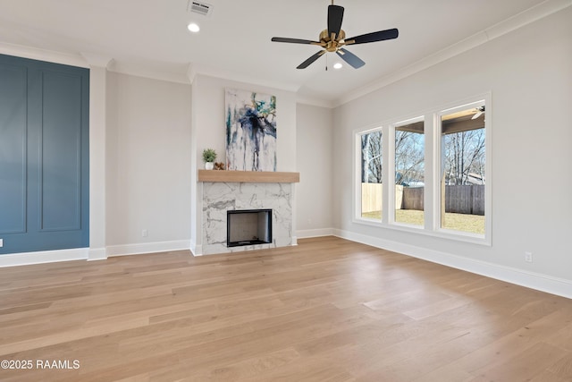 unfurnished living room with crown molding, a fireplace, visible vents, light wood-style flooring, and baseboards