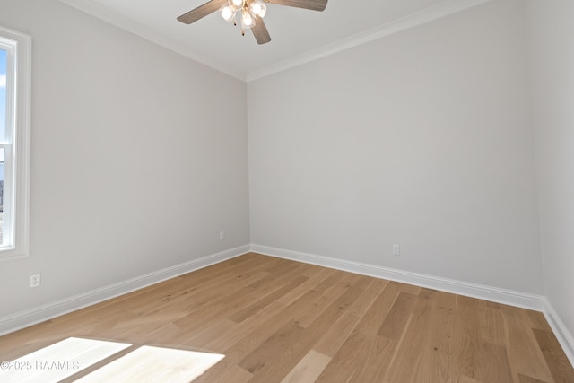 unfurnished room featuring light wood-style flooring, baseboards, ceiling fan, and crown molding