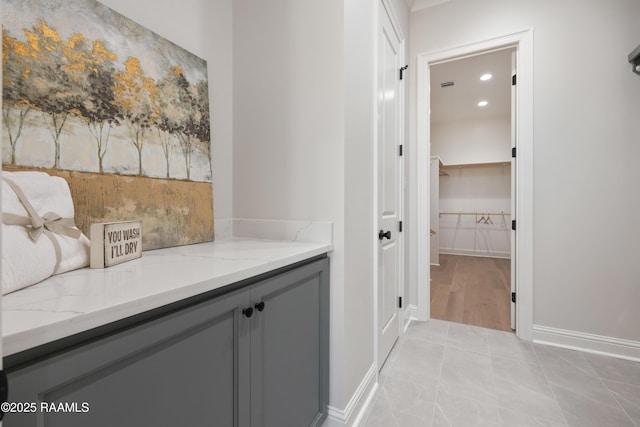 bathroom with tile patterned flooring, vanity, baseboards, and recessed lighting