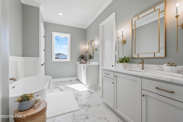 full bathroom featuring a soaking tub, a sink, marble finish floor, crown molding, and two vanities