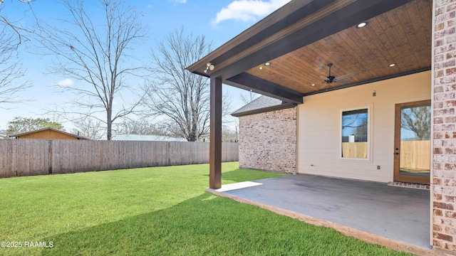 view of yard featuring ceiling fan, a fenced backyard, and a patio