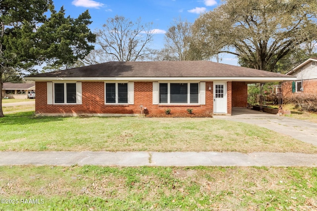 ranch-style home featuring driveway, brick siding, an attached carport, and a front yard