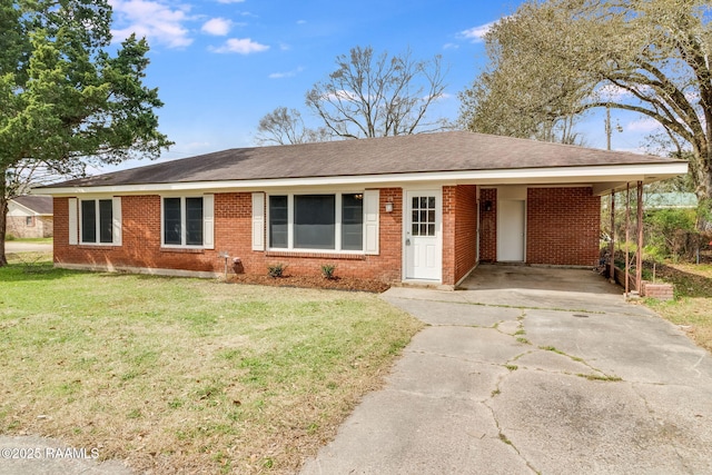 ranch-style home featuring a carport, brick siding, driveway, and a front lawn