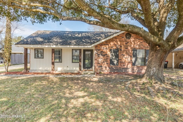 ranch-style home with covered porch and a front lawn