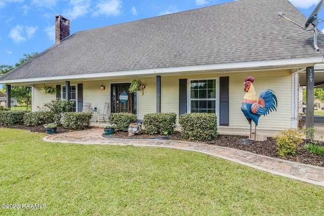 view of front of house with covered porch and a front lawn