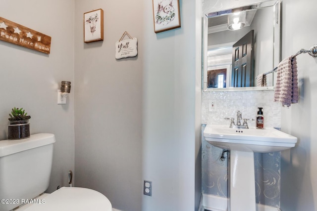 bathroom with backsplash and toilet