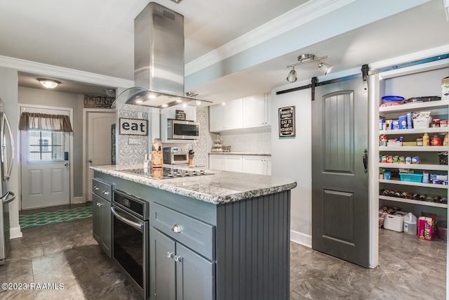 kitchen with stainless steel appliances, a center island, white cabinets, island exhaust hood, and a barn door