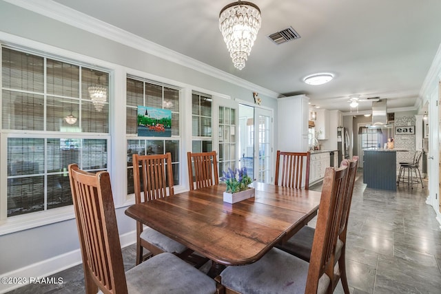 dining area with a notable chandelier and crown molding