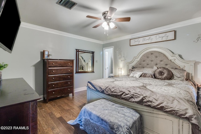 bedroom with ornamental molding, dark hardwood / wood-style floors, and ceiling fan