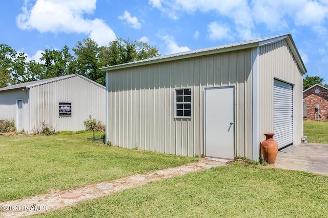 view of outbuilding with a garage and a lawn