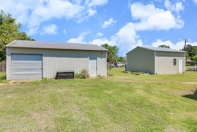 exterior space with a garage and an outbuilding