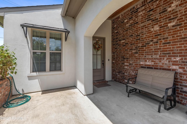 doorway to property with a patio area