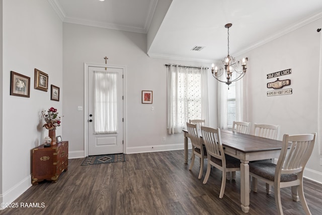 dining area featuring crown molding, dark wood-type flooring, and a chandelier