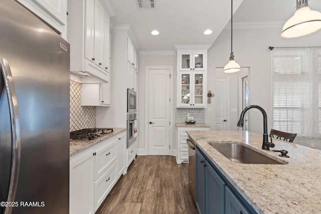 kitchen with blue cabinets, white cabinetry, appliances with stainless steel finishes, and hanging light fixtures