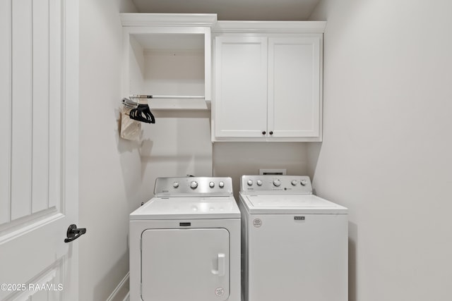 washroom with cabinets and washer and clothes dryer