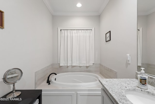 bathroom with vanity, a tub, and ornamental molding