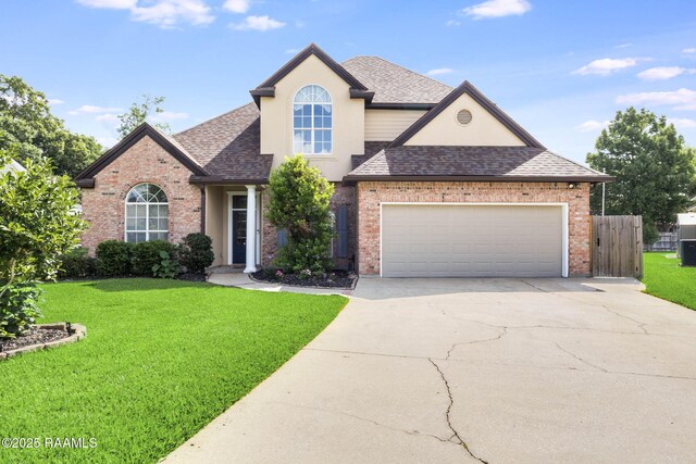 110 Yorkshire Cir, Lafayette, LA 70508 - traditional home featuring brick siding, a shingled roof, concrete driveway, and an attached garage