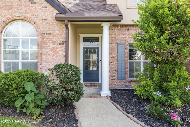 110 Yorkshire Cir, Lafayette, LA 70508 - view of exterior entry with a shingled roof, brick siding, and stucco siding