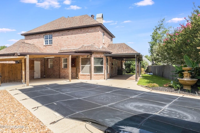 110 Yorkshire Cir, Lafayette, LA 70508 - back of house with brick siding, a patio, a chimney, and roof with shingles