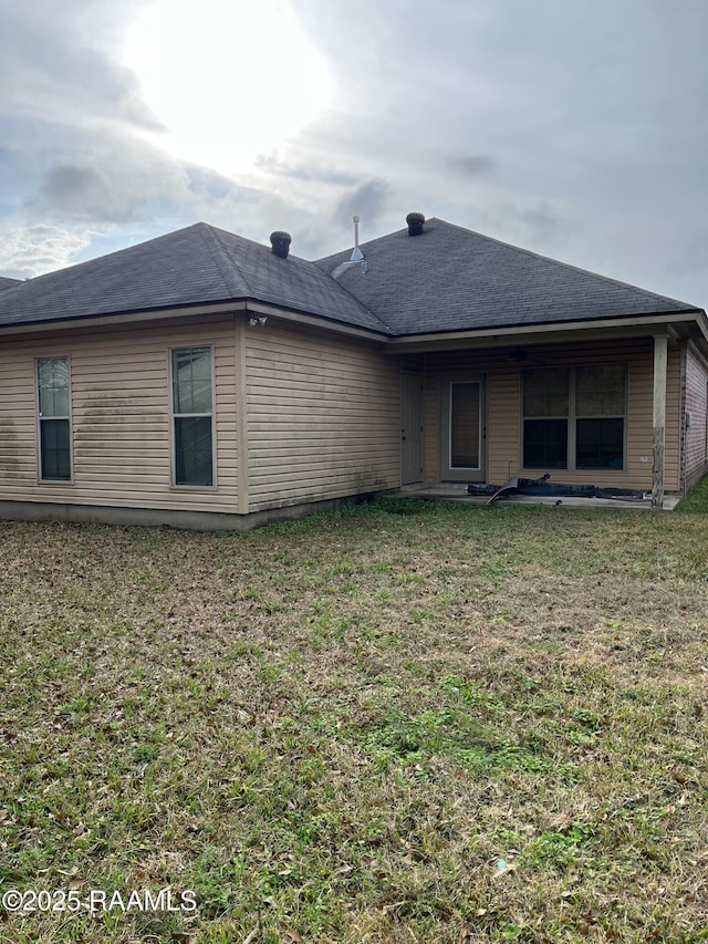 back of house with a yard