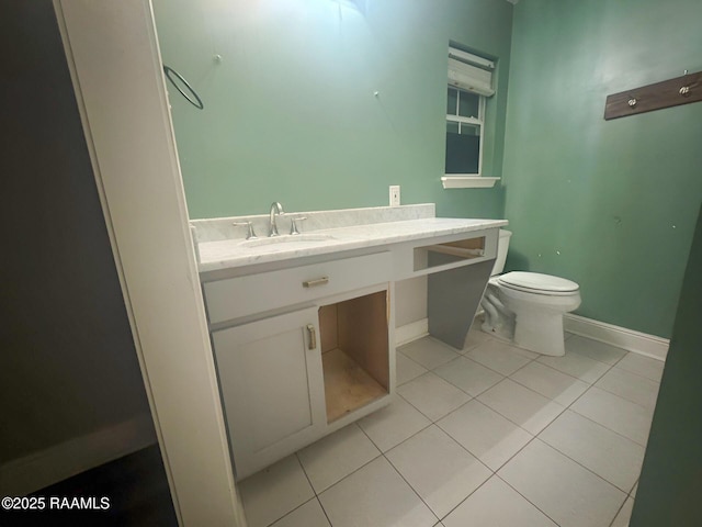 bathroom featuring vanity, tile patterned floors, and toilet