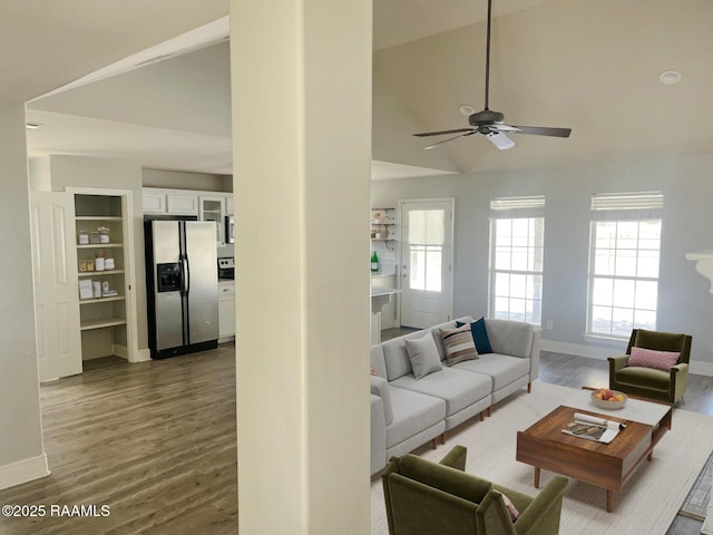 living room with ceiling fan, dark hardwood / wood-style flooring, and high vaulted ceiling