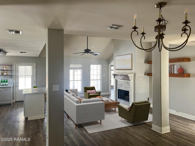 living room featuring lofted ceiling, dark wood-type flooring, and ceiling fan