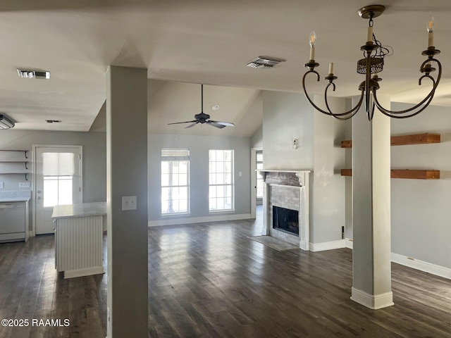 unfurnished living room featuring vaulted ceiling, ceiling fan with notable chandelier, and dark hardwood / wood-style flooring