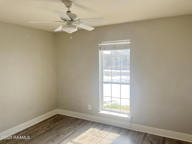 spare room featuring dark wood-type flooring and ceiling fan