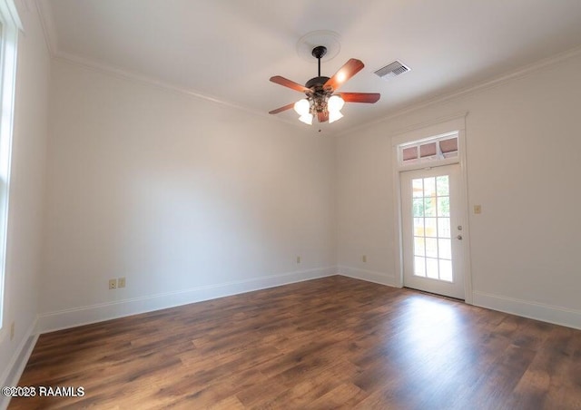 empty room with crown molding, ceiling fan, and dark hardwood / wood-style floors