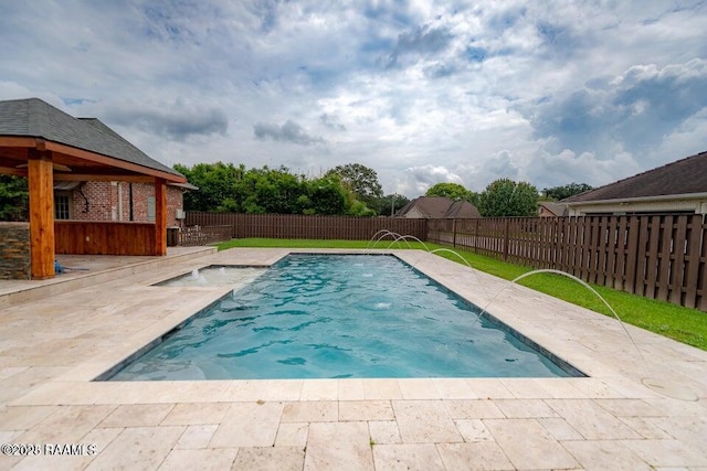 view of swimming pool featuring pool water feature and a patio area