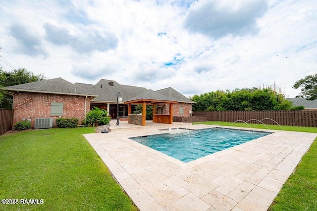 view of pool featuring a yard, a gazebo, central AC unit, a patio area, and pool water feature