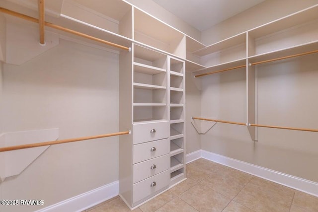 walk in closet with tile patterned flooring