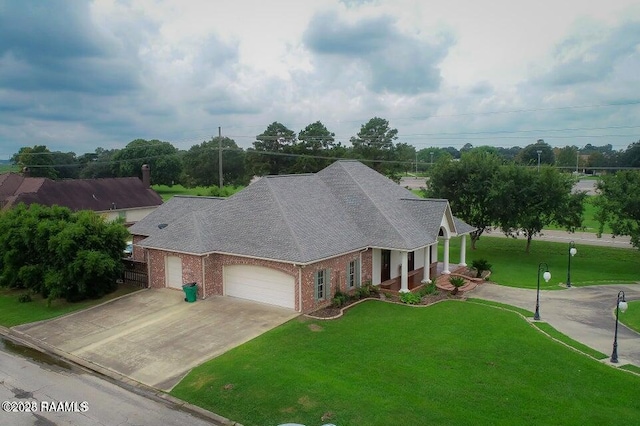 view of front of house featuring a garage and a front lawn