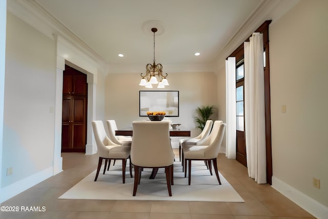 tiled dining room featuring an inviting chandelier and ornamental molding