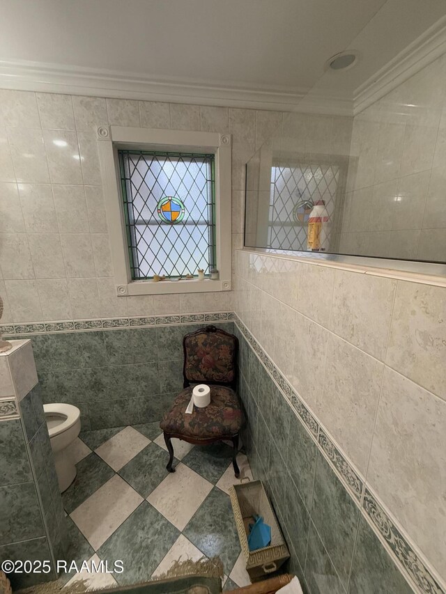 bathroom with ornamental molding, tile walls, and toilet