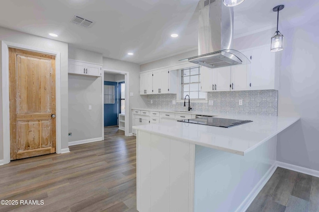 kitchen with white cabinetry, island range hood, decorative light fixtures, black electric cooktop, and dark hardwood / wood-style floors