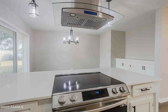 kitchen featuring pendant lighting, stainless steel electric stove, a chandelier, and white cabinets