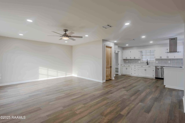 kitchen featuring white cabinetry, backsplash, island range hood, dark hardwood / wood-style flooring, and stainless steel dishwasher