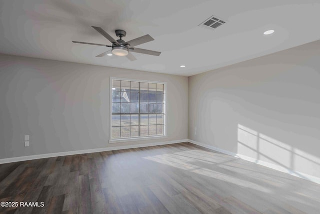 spare room featuring hardwood / wood-style floors and ceiling fan