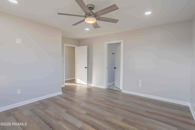 spare room featuring hardwood / wood-style flooring and ceiling fan