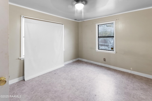 spare room with ornamental molding and ceiling fan