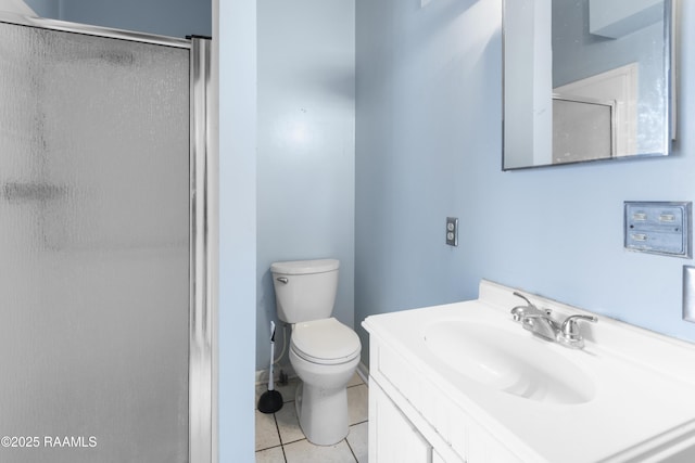 bathroom featuring tile patterned floors, toilet, a shower with door, and vanity