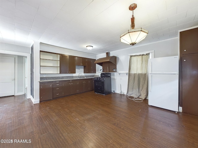 kitchen with black gas range oven, dark hardwood / wood-style floors, sink, white refrigerator, and dark brown cabinetry