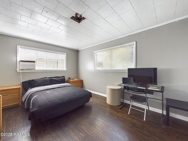 bedroom featuring dark wood-type flooring, crown molding, and cooling unit